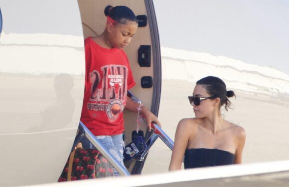 North West clutch onto expensive designer bags at end of trip to Japan