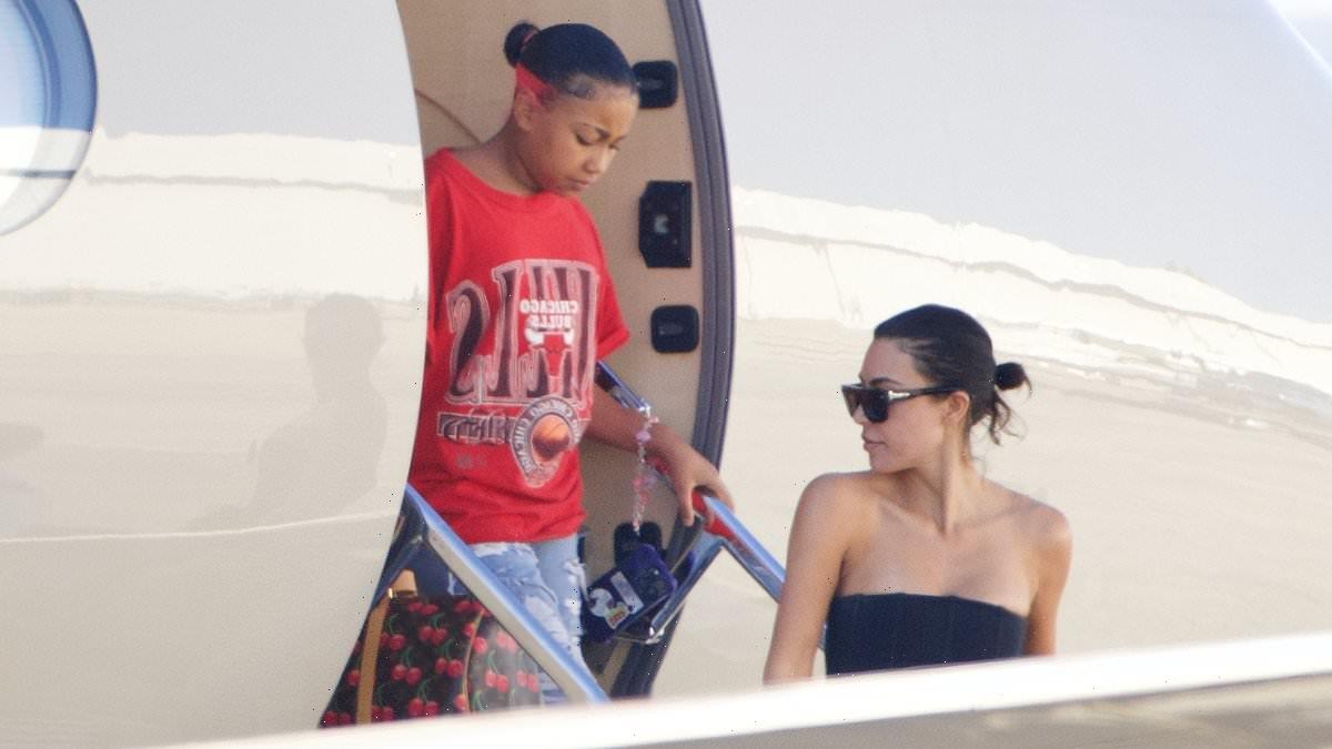 North West clutch onto expensive designer bags at end of trip to Japan