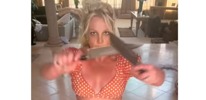 Britney Spears wears bandage on arm after playing with KNIVES in video