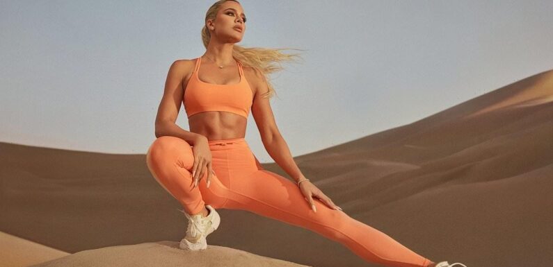 Khloe Kardashian puts her abs on display in a bra top for Fabletics