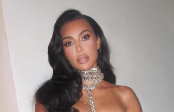 Kim Kardashian showcases her flat midriff in electric blue bikini top