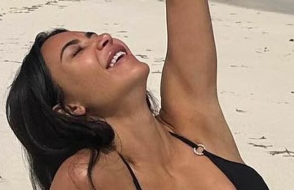 Kim Kardashian shows off her jaw-dropping figure in busty black bikini