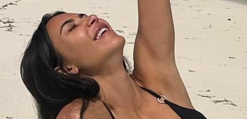 Kim Kardashian shows off her jaw-dropping figure in busty black bikini