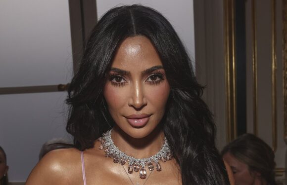 Kim Kardashian wears a silk gown at Victoria Beckham's PFW show