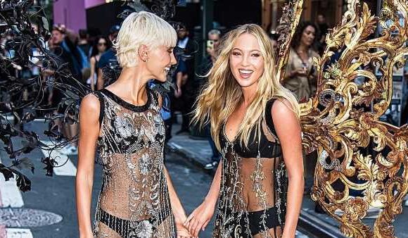 Lila Moss holds hands with Iris Law at Victoria's Secret show