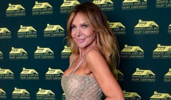 Lizzie Cundy puts on VERY busty display in gold dress for charity ball