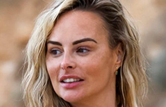 Rhian Sugden flaunts her famous curves in VERY plunging swimsuit