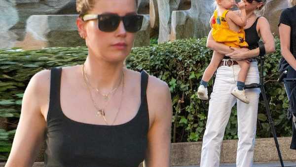 Amber Heard walks with a crutch while out with her daughter in Madrid