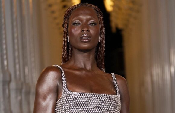 Jodie Turner-Smith flashes her washboard abs in a silver chainmail bra